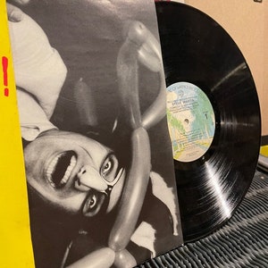 May include: A black vinyl record with a white label featuring a photo of Steve Martin. The album cover features a black and white photo of Steve Martin with a surprised expression, surrounded by balloons.