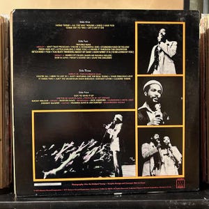 May include: Album cover for Marvin Gaye's album, featuring a black background with song titles and artist photos. The album's title is not visible. The back cover includes song titles and credits, with multiple images of the artist.