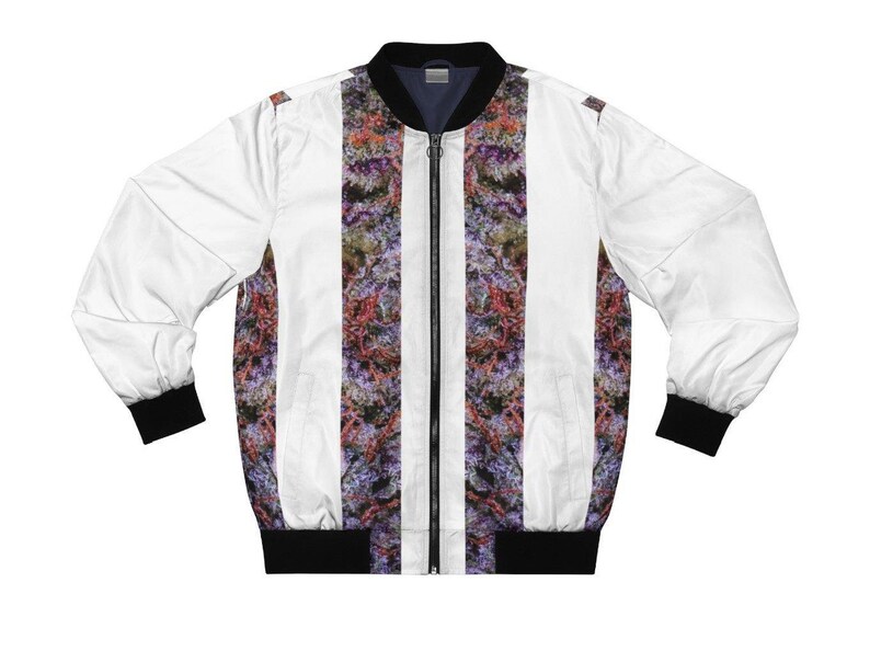 May include: White bomber jacket with a zip fastening and black ribbed trim. The jacket features a vertical striped pattern with a colourful marijuana leaf design.