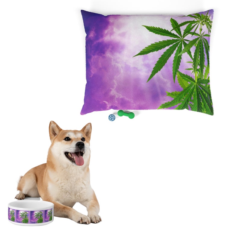 May include: A purple and green dog bed featuring a marijuana leaf design. The bed is filled with a soft, comfortable material.