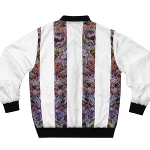 May include: A white bomber jacket with vertical stripes of a purple and green floral pattern. The jacket has a black ribbed collar, cuffs, and waistband.