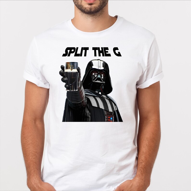 May include: A white t-shirt with a black graphic of Darth Vader holding a glass of Guinness with the text "SPLIT THE G" above him.