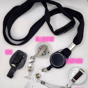 May include: A collection of black lanyards, badge reels, and accessories. Includes a black lanyard with a plastic clasp, a black badge reel, a clear plastic belt clip, and an MRI clip.