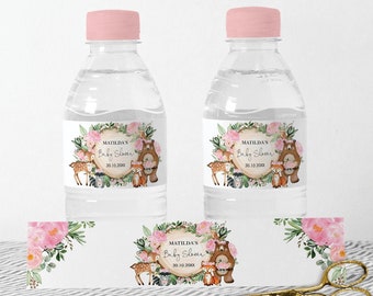 May include: Two clear plastic water bottles with pink lids and labels. The labels feature a woodland theme with a deer, fox, bear, and owl. The text on the labels reads "Matilda's Baby Shower 20.10.20XX".