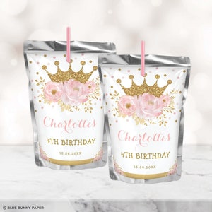 May include: Two silver juice pouches with pink straws. The pouches have a white label with a gold glitter crown, pink flowers, and gold leaves. The text on the label reads "Charlotte's 4th Birthday 15.06.20XX".