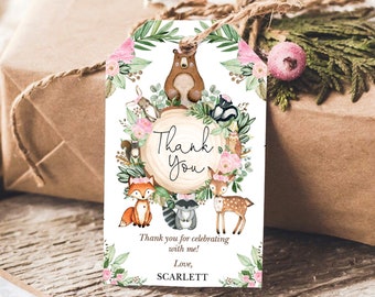 May include: A white thank you tag with a watercolor illustration of woodland animals, including a bear, fox, deer, raccoon, and squirrel. The animals are surrounded by greenery and pink flowers. The text "Thank You" is written in black script on a brown wooden circle. The text "Thank you for celebrating with me! Love, SCARLETT" is printed below the illustration.
