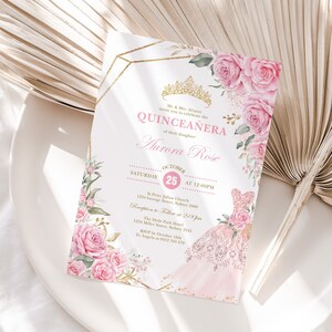 May include: A pink and gold Quincea&ntilde;era invitation with a floral design. The invitation features a crown, a dress, and the text "Quincea&ntilde;era" and "Aurora Rose". The date and time of the event are also included.
