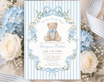 May include: A rectangular baby shower invitation card featuring a light blue and white vertical striped background. The center displays a teddy bear illustration with a blue bow, surrounded by a floral wreath and the text We Can Bearly Wait.