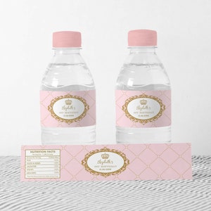 May include: Pink and gold water bottle labels with a crown and the text "Elizabeth's 1st Birthday 12.08.20XX".