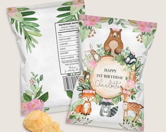 May include: A white chip bag with a woodland animal theme. The bag features a brown bear, a fox, a raccoon, a deer, and a squirrel. The bag is decorated with pink flowers and green leaves. The text on the bag reads "Happy 1st Birthday Charlotte".