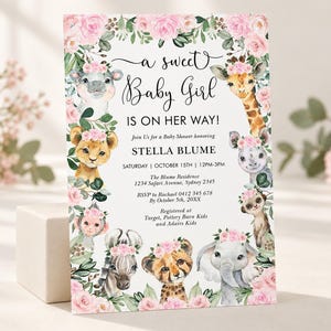May include: A rectangular baby shower invitation card featuring a floral border of pink roses and green leaves. The center text reads A sweet Baby Girl IS ON HER WAY! honoring Stella Blume, with event details and illustrations of safari animals.