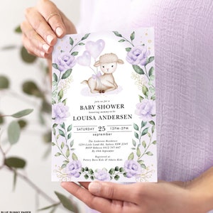May include: A baby shower invitation featuring a charming cartoon lamb holding pink and white balloons. The invitation is adorned with purple flowers and green leaves. The text on the invitation reads "Join us for a Baby Shower honouring mummy-to-be Louisa Andersen Saturday 25 12PM-2PM September The Andersen Residence 1234 Little Lamb Rd, Sydney NSW 2345 RSVP Rebecca 0412 345 667 By 10th September Registered at Pottery Barn Kids & Adairs Kids"