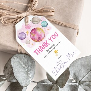 May include: Pink and gold space-themed thank you tag with the text "THANK YOU" and "for coming and celebrating and me!" with a handwritten signature that says "love, Stella Mia".