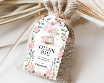 Pode incluir: Uma etiqueta de agradecimento branca com um design floral rosa e um cordeiro fofo segurando balões rosas. O texto na etiqueta diz "Obrigado por vir e celebrar conosco! com amor, Catherine".