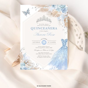 May include: A blue and white quincea&ntilde;era invitation with a floral design and a crown. The invitation includes the text "Quincea&ntilde;era" and "Aurora Rose". The date of the event is October 25th. The invitation also includes the location of the event, St. Peter Julian Church, and the time, 12:00 PM.