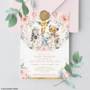 May include: Pink and gold baby shower invitation with a floral wreath and a group of jungle animals including a giraffe, zebra, elephant, and cheetah. The text reads "Please join us for a Baby Shower honouring Mommy-to-be Savannah Phillips Saturday 30th October 3PM The Phillips Residence 1234 Safari Parade, Sydney 2345 RSVP to Belinda 0412 345 667 by 10.12.20XX Registered at Pottery Barn Kids & Target"