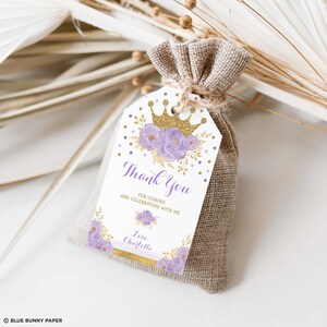 May include: Purple and gold thank you favor bag tag with a crown, flowers, and gold glitter. The text reads "Thank You for coming and celebrating with me. Love Charlotte."