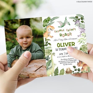 May include: A green and brown dinosaur-themed birthday invitation with a photo of a baby boy. The invitation says "Stomp! Chomp! Roar!! Let's Party Like a Dinosaur! Oliver is turning one! Apr 25 at 2 o'clock in the afternoon. The Williams Residence 123 Dinamite Road, Sydney 2345 RSVP Bettina 0412 345 678 By 10th October"