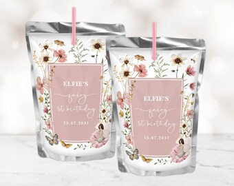 May include: Two silver juice pouches with pink straws and floral designs. The pouches have labels with the text "Elfie's fairy 1st birthday 15.07.2031".