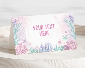 May include: A white card with a pink watercolor background featuring a seahorse, starfish, and coral. The text "YOUR TEXT HERE" is printed in pink on the card.