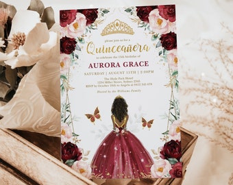 May include: A Quinceañera invitation with a burgundy and gold color scheme. The invitation features a floral design with butterflies and a crown. The text on the invitation reads "Please join us for a Quinceañera to celebrate the 15th birthday of Aurora Grace. Saturday | August 15th | 2:00PM. The Hyde Park Hotel 1234 Miller Street, Sydney 2345. RSVP by October 10th to Angela at 0412 345 678. Hosted by the Williams Family."