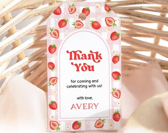 May include: Pink and white gingham thank you tag with a red strawberry pattern. The tag has a white arch with the text "Thank You" in red and the text "for coming and celebrating with us! with love, AVERY" in black.