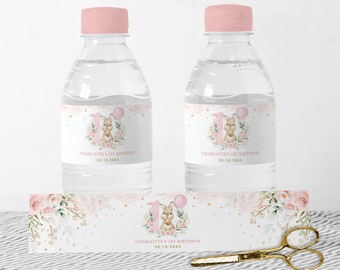 May include: Water bottle labels with a pink and gold floral design featuring a bunny with a balloon. The labels say "Charlotte's 1st Birthday" and "30.10.20XX".