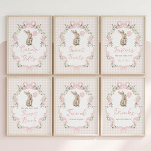 May include: Six framed signs with a pink and white gingham pattern. Each sign features a watercolour illustration of a bunny holding a balloon, surrounded by floral accents and text. The signs read "Cards and Gifts", "Sweet Treats", "Favors", "Guest Book", "Food", and "Drinks".