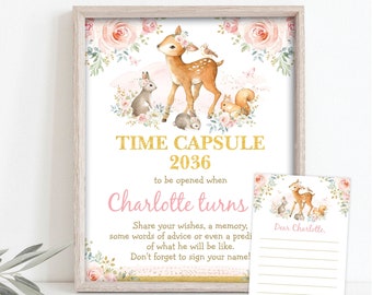 May include: A printable time capsule sign with a pink and gold color scheme. The sign features a watercolor illustration of a deer with a floral crown, surrounded by bunnies and birds. The text reads "Time Capsule 2036 to be opened when Charlotte turns. Share your wishes, a memory, some words of advice or even a prediction of what he will be like. Don't forget to sign your name!"