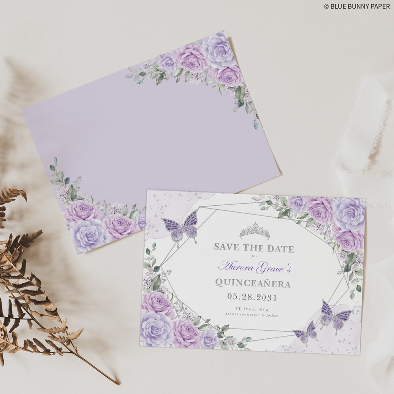 May include: Purple and white floral save the date card with a silver geometric frame and butterflies. The text reads "Save the Date for Aurora Grace's Quincea&ntilde;era 05.28.2031 St Ives, NSW formal invitation to follow."