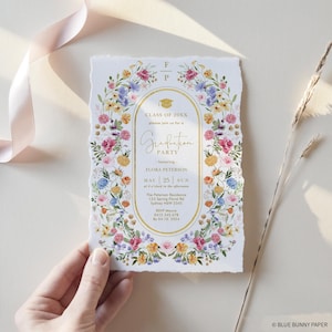May include: Graduation party invitation with a floral border. The invitation features an oval frame with gold text that reads "Graduation Party" and the name "Flora Peterson." The date is May 25th. The invitation is surrounded by colorful flowers.