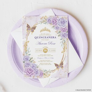 May include: Purple and gold quincea&ntilde;era invitation with a floral design and butterflies. The invitation includes the date, time, and location of the event. The text reads "Mr. & Mrs. Alvarez invite you to celebrate the Quincea&ntilde;era of their daughter Aurora Rose. October 25th at 12:00 PM. St. Peter Julian Church, 1234 George Street, Sydney 7000. Reception to follow at 2:00 PM. The Hyde Park Hotel, 1234 Miller Street, Sydney 2545. RSVP by October 10th to Angela at 0412 345 678."