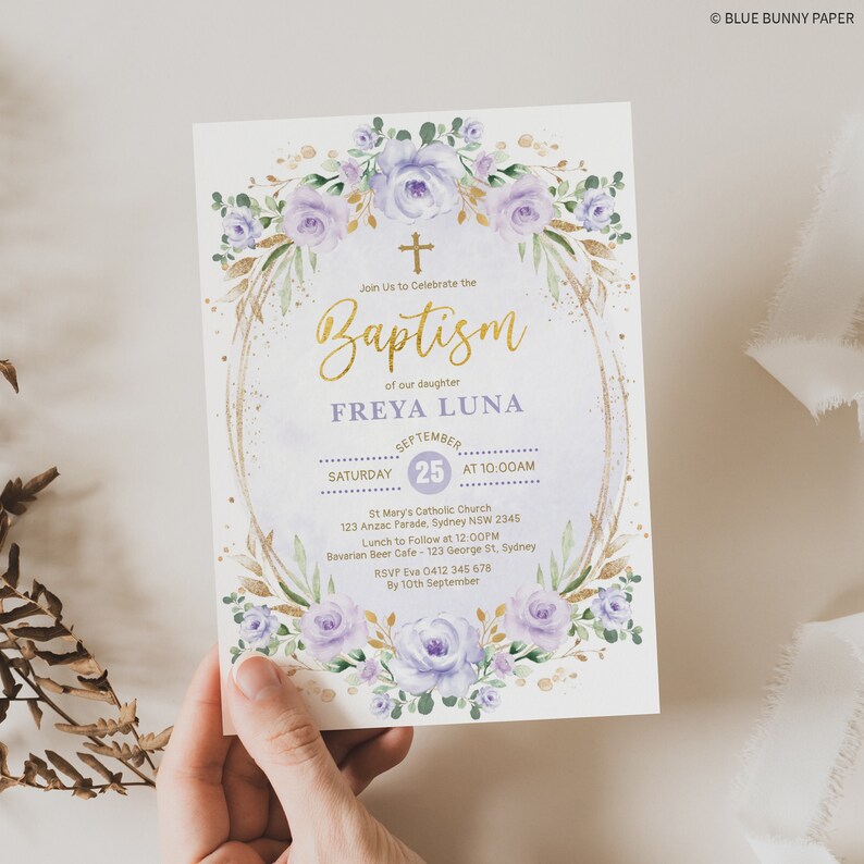 May include: Purple and gold baptism invitation with a floral design and the text "Join Us to Celebrate the Baptism of our daughter FREYA LUNA September 25 at 10:00AM St Mary's Catholic Church 123 Anzac Parade, Sydney NSW 2345 Lunch to Follow at 12:00PM Bavarian Beer Cafe - 123 George St, Sydney RSVP Eva 0412 345 678 By 10th September"