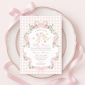 May include: A baby shower invitation with a pink gingham background and a decorative frame. The invitation features a whimsical illustration of two geese and the text "A Sweet Little Silly Goose". Ribbons and floral accents complete the design.