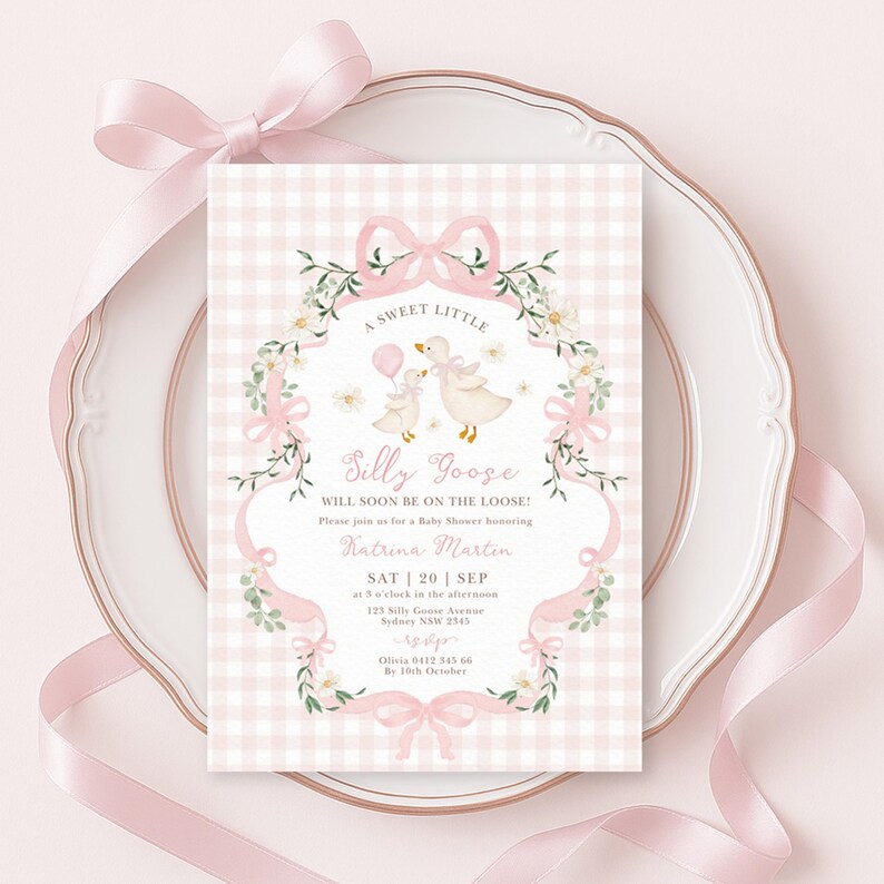 May include: A baby shower invitation with a pink gingham background and a decorative frame. The invitation features a whimsical illustration of two geese and the text "A Sweet Little Silly Goose". Ribbons and floral accents complete the design.