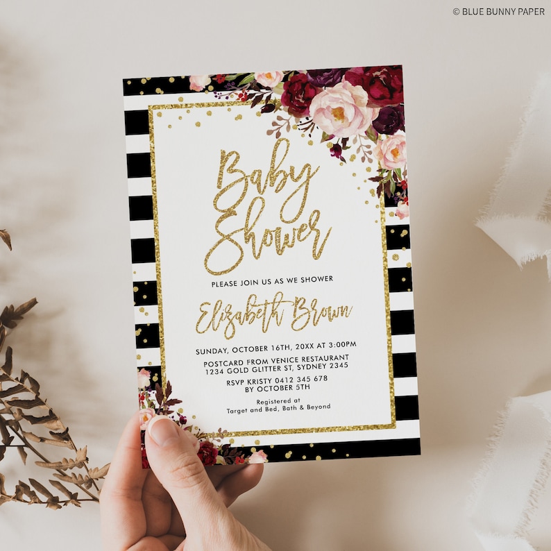 May include: A black and white striped baby shower invitation with gold glitter accents and a floral design. The invitation reads "Baby Shower" and "Please join us as we shower Elizabeth Brown". The invitation includes the date, time, location, RSVP information, and registry details.