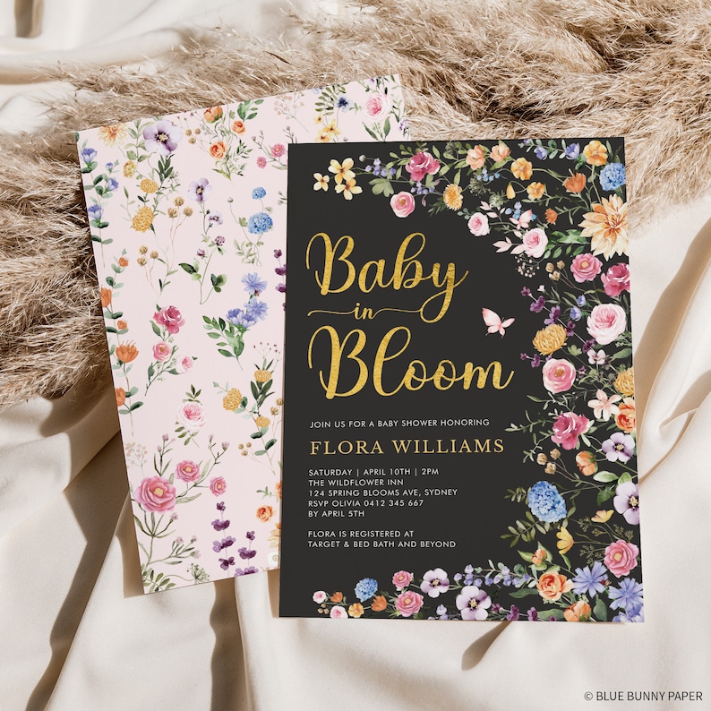 May include: A black baby shower invitation with gold lettering that reads "Baby in Bloom" and floral illustrations. The invitation includes the name Flora Williams, the date and time of the shower, the location, and RSVP information. The text "Flora is registered at Target & Bed Bath and Beyond" is also included.