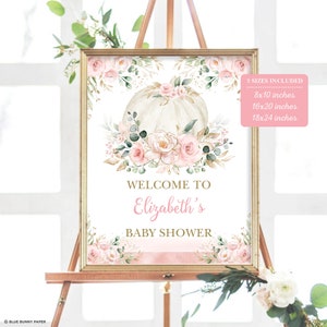 Puede incluir: Un cartel de bienvenida imprimible para un baby shower con una calabaza acuarela, flores rosas y detalles dorados. El cartel dice "Bienvenido a la fiesta de bienvenida de Elizabeth". Est&aacute; disponible en tres tama&ntilde;os: 20,3 x 25,4 cm, 40,6 x 50,8 cm y 45,7 x 61 cm.