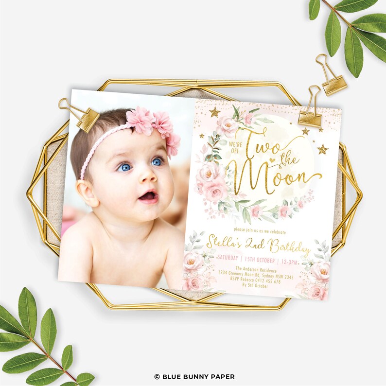 May include: A pink and gold birthday invitation with a photo of a baby girl. The invitation says "We're off to the moon" and features a moon with pink flowers and gold stars. The text also includes the details of the birthday party, including the date, time, and location.