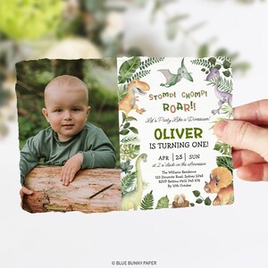 May include: A green and brown dinosaur-themed first birthday party invitation with a photo of a baby boy. The invitation features the text "Stomp! Chomp! Roar!! Let's Party Like a Dinosaur! Oliver is Turning One! APR 25 SUN at 2 o'clock in the afternoon The Williams Residence 123 Dinomite Road, Sydney 2345 RSVP Bettina 0412 345 678 By 10th October".
