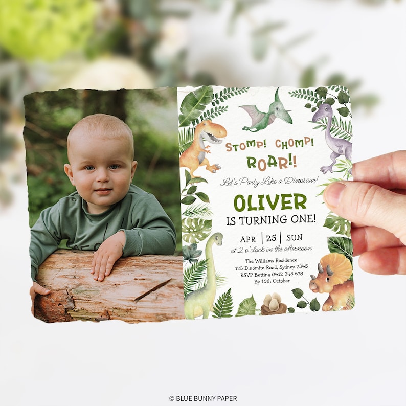 May include: A green and brown dinosaur-themed first birthday party invitation with a photo of a baby boy. The invitation features the text "Stomp! Chomp! Roar!! Let's Party Like a Dinosaur! Oliver is Turning One! APR 25 SUN at 2 o'clock in the afternoon The Williams Residence 123 Dinomite Road, Sydney 2345 RSVP Bettina 0412 345 678 By 10th October".
