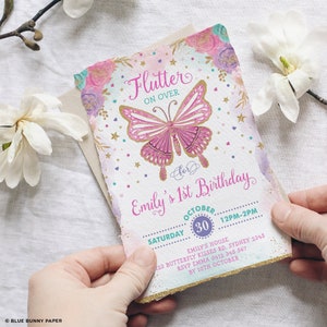 May include: A pink and gold butterfly with glitter accents on a white background. The text "Flutter On Over" is above the butterfly. The text "for Emily's 1st Birthday" is below the butterfly. The text "Saturday October 30 12PM-2PM" is below the butterfly. The text "Emily's House 123 Butterfly Kisses Rd, Sydney 2345 RSVP Emma 0412 345 567 By 10th October" is below the butterfly.