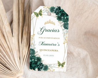 May include: Green and gold thank you tag with a gold crown and butterflies. The text reads "Gracias por acompañarnos Xiomara's Quinceañera 15.05.2031"
