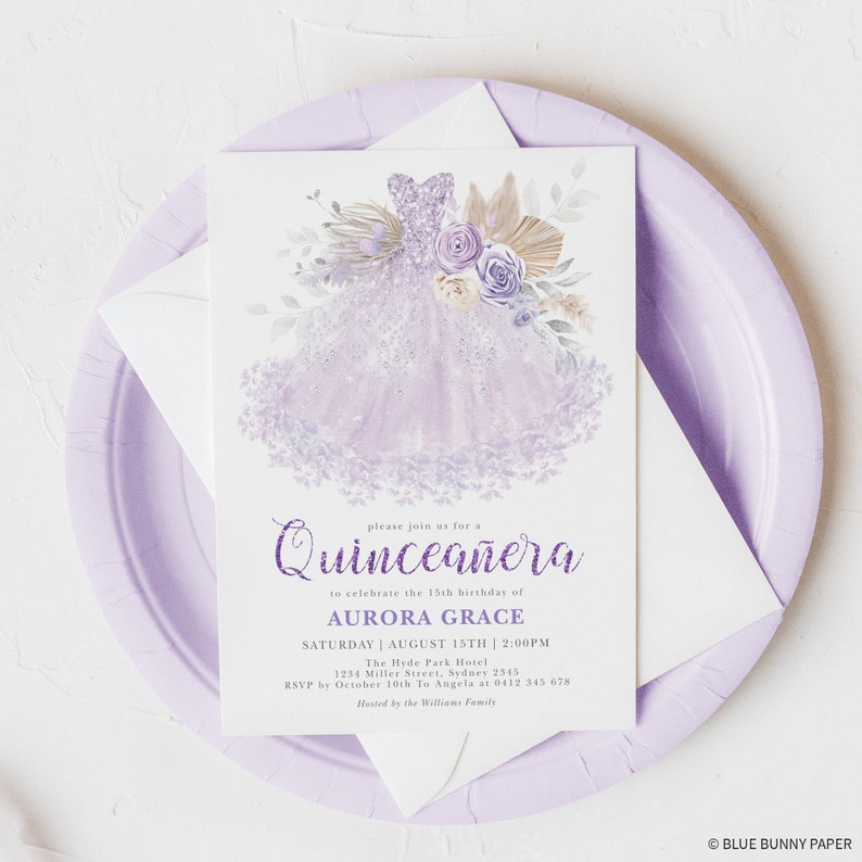 May include: Purple Quincea&ntilde;era invitation with a watercolor illustration of a lavender dress with floral accents. The text reads "Please join us for a Quincea&ntilde;era to celebrate the 15th birthday of Aurora Grace. Saturday, August 15th, 2:00 PM. The Hyde Park Hotel, 1254 Miller Street, Sydney 2545. RSVP by October 10th to Angela at 0412 345 678. Hosted by the Williams Family."