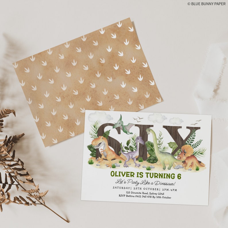 May include: A dinosaur-themed birthday invitation for a 6-year-old boy named Oliver. The invitation features a brown wooden background with the number six spelled out in large letters. The letters are surrounded by dinosaurs and greenery. The text on the invitation reads "Oliver is turning 6, Let's Party Like a Dinosaur!" with the date, time, and RSVP information below.