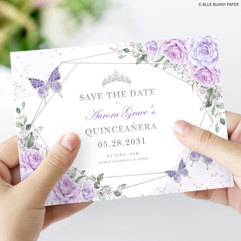 May include: Save the date card with a silver geometric frame and purple flowers. The text reads "Save the Date for Aurora Grace's Quincea&ntilde;era 05.28.2031 ST IVES, NSW formal invitation to follow".