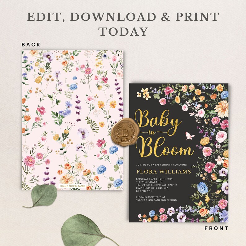 May include: Baby shower invitation with a floral design. The front of the invitation is black with gold lettering that says "Baby in Bloom" and is surrounded by a floral border. The back of the invitation is pink with a floral pattern.