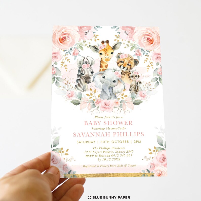 May include: A pink and gold baby shower invitation featuring a floral wreath and a group of safari animals including a giraffe, zebra, elephant, and cheetah. The text on the invitation reads "Please Join Us for a Baby Shower honouring Mommy-To-Be SAVANNAH PHILLIPS SATURDAY 30TH OCTOBER | 3PM The Phillips Residence 1234 Safari Parade, Sydney 2345 RSVP to Belinda 0412 345 667 by 10.12.20XX Registered at Pottery Barn Kids & Target BLUE BUNNY PAPER"