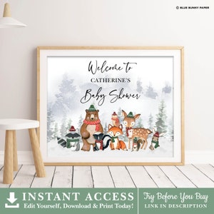 May include: A printable welcome sign for a baby shower with a winter woodland theme. The sign features a watercolor background with a snowy forest scene and a group of animals wearing winter hats and scarves. The text on the sign reads "Welcome to Catherine's Baby Shower".