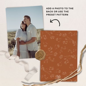 May include: A wedding invitation with a brown background and a floral pattern. The invitation has a wax seal with the letter "B" on it. The text on the invitation says "Blue Button".